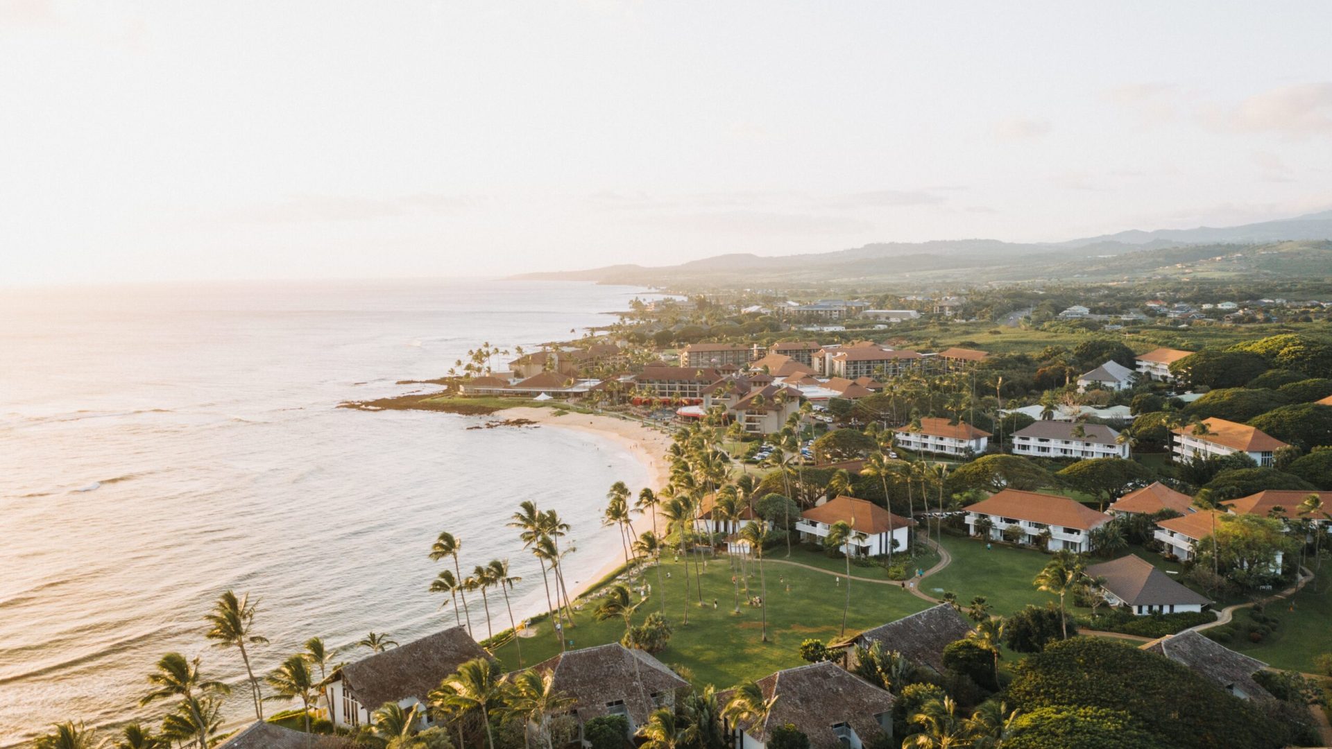 A high angle shot of buildings in a beautiful seashore with a clear blue sky in the background